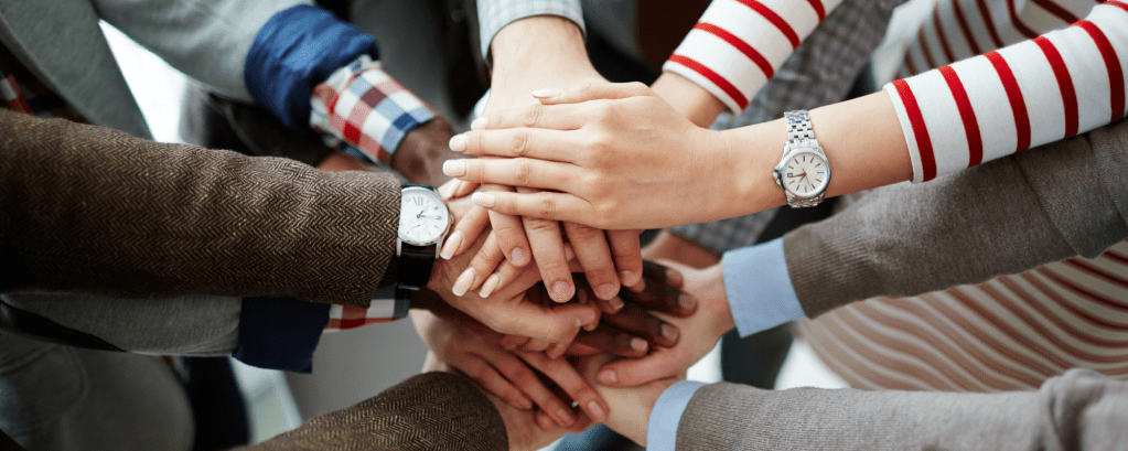 Adults put their hands into a circle and their hands touch