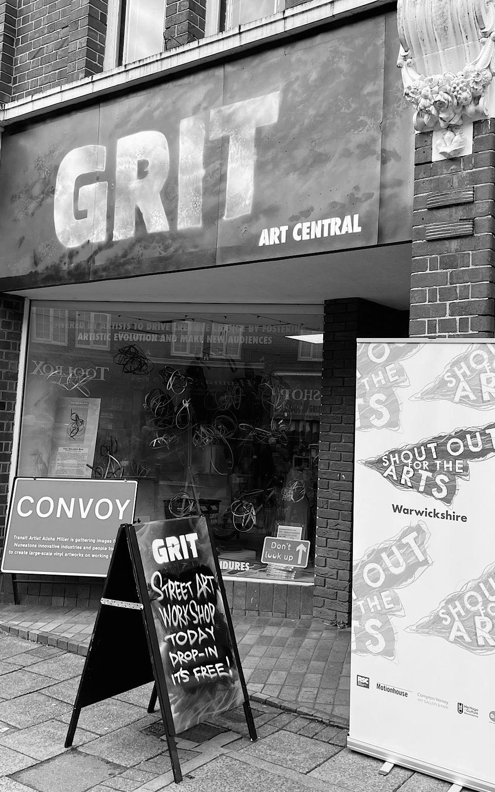 A sign above a shop reads GRIT Art Central
