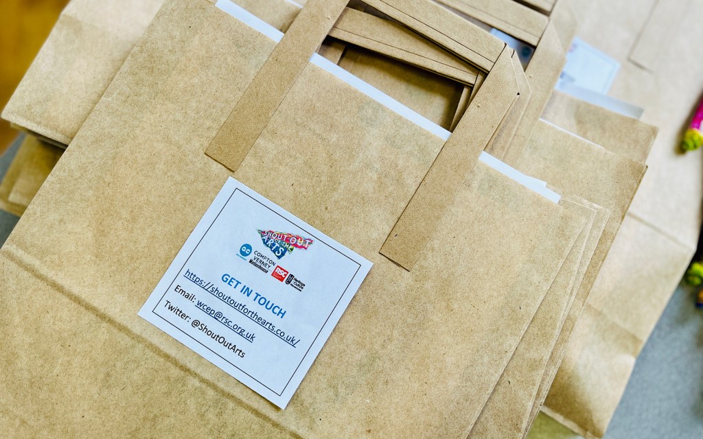 Brown paper bags on a table at a student fair