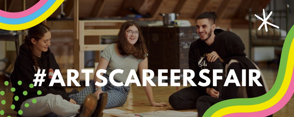 A group of four students sitting on the floor as part of a workshop