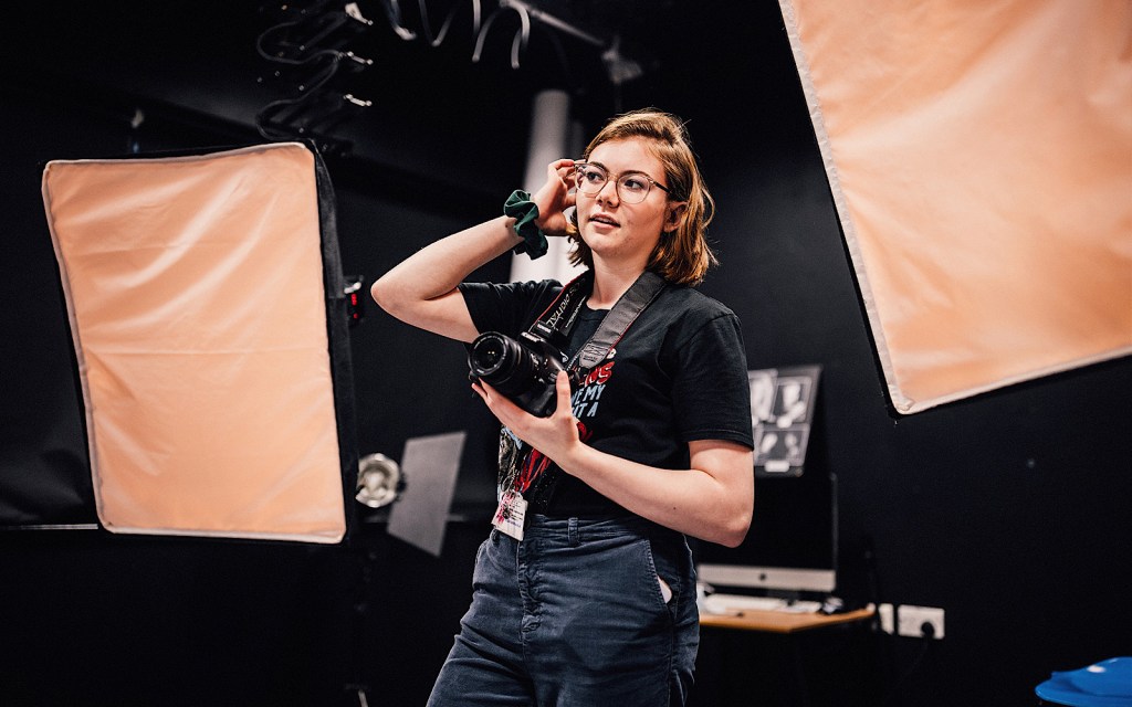 A student is using a professional camera at college