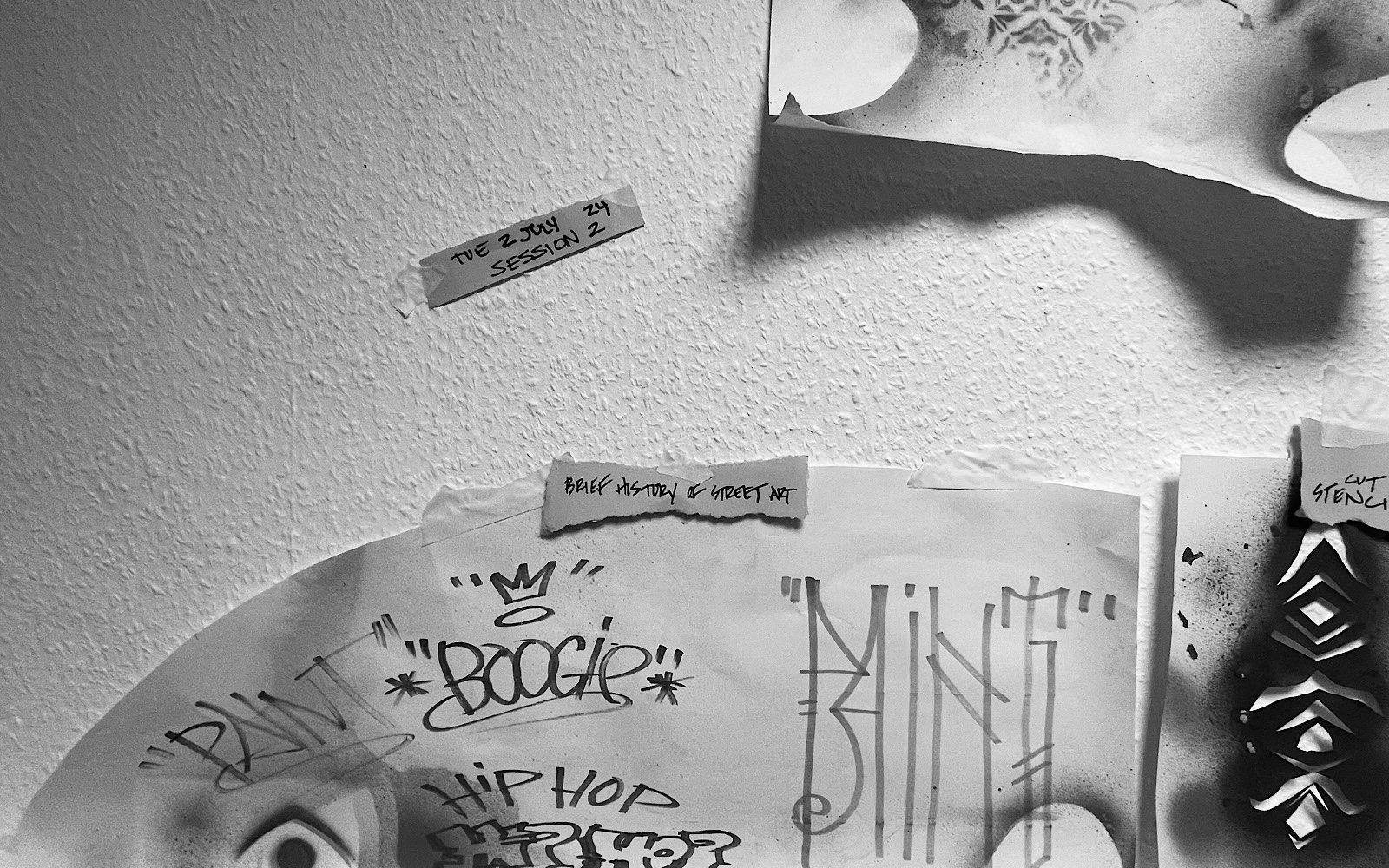 Tape on a wall reads ‘Tue 2 July 24 session 2’