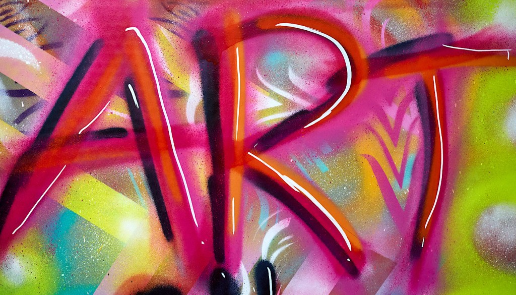 The word ‘art’ has been spray painted