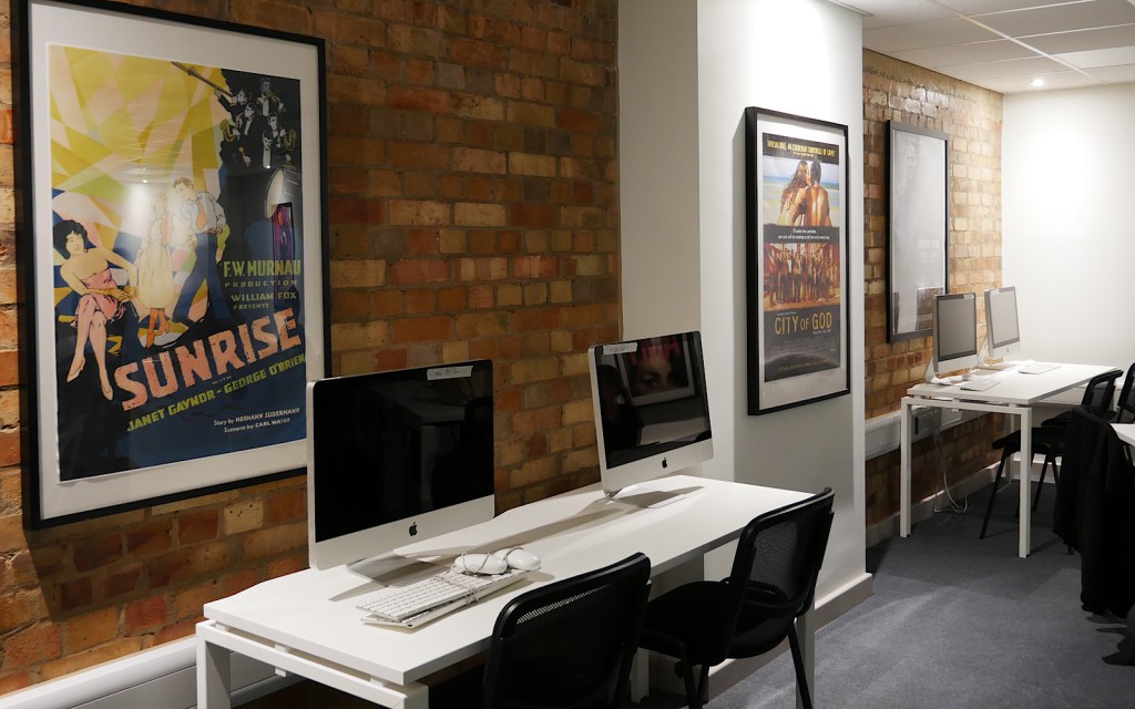 A desk with two computers in a college