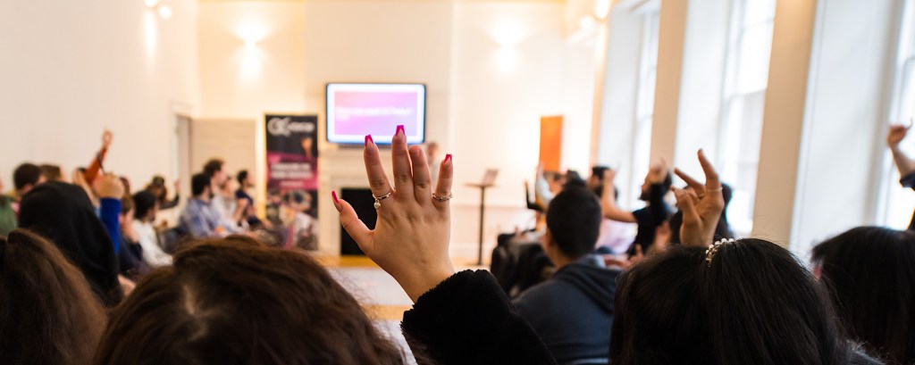 Hands raised in an educational workshop