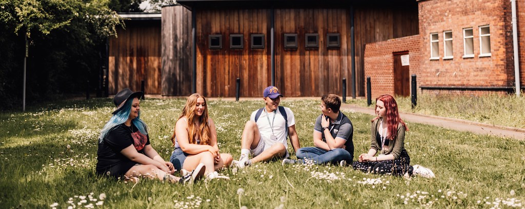 Students sit on the grass outside a college in Nuneaton