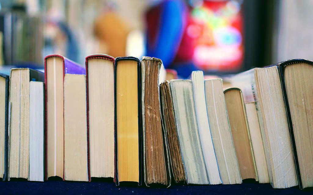 A pile of books on a shelf in a library
