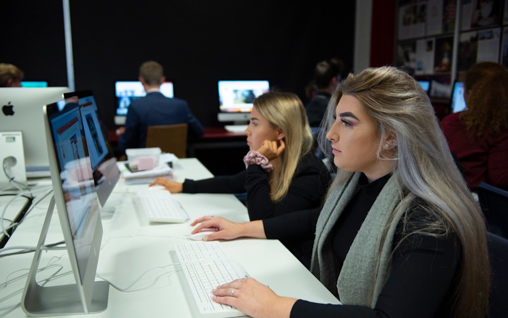 Two students working on computers