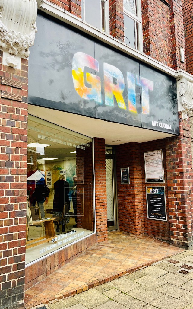 A shop has the word GRIT written above the entrance