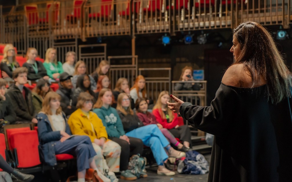 A writer talks to a room of young people