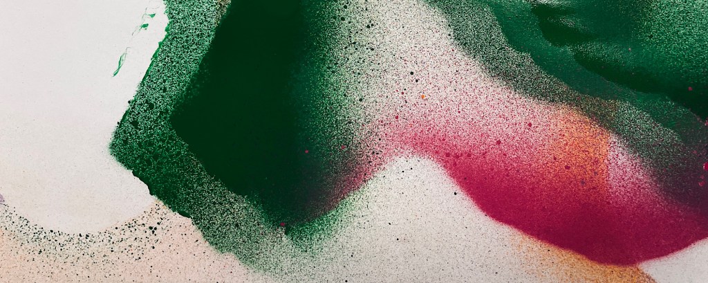 A close-up of green and pink paint