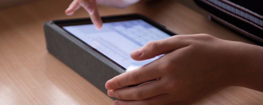 A student types on an ipad