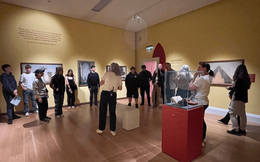 Young students walk around an art gallery