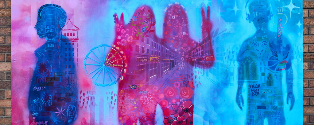 A pink and purple mural is made up of shapes of people and images of a town in the background